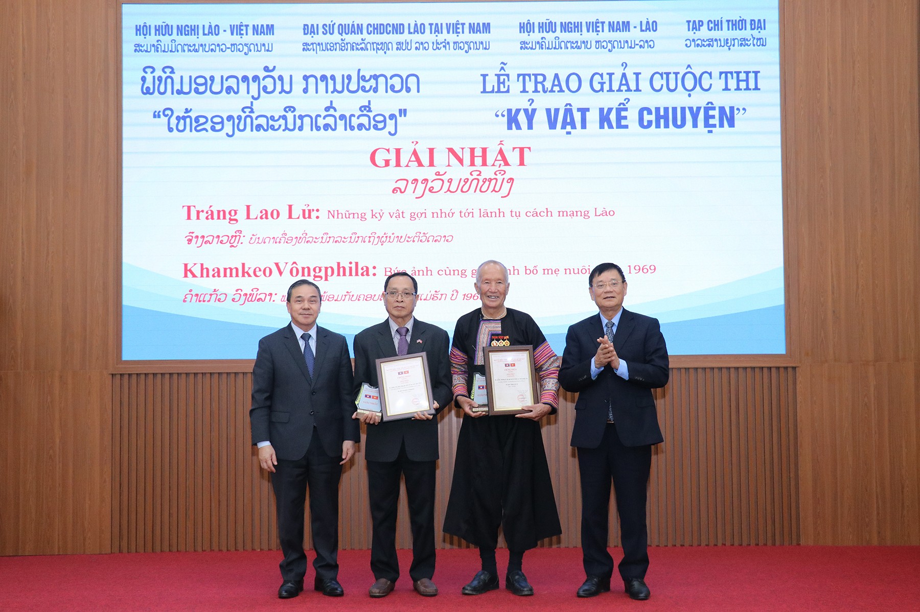 Đại sứ  Đặc mệnh toàn quyền nước Cộng hòa Dân chủ Nhân dân Lào tại Việt NamSẻng Phết Hùng Bun Nhuông (ngoài cùng bên trái) và ông Trần Văn Túy, Chủ tịch Hội hữu nghị Việt Nam - Lào trao giải Nhất cho hai tác giả Tráng Lao Lử và Khamkeo Vôngphila (Ảnh: Thu
