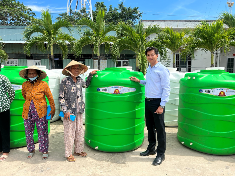 Đại diện Tập đoàn Tân Á Đại Thành trao tặng bồn nước cho người dân xã Vĩnh Hậu.