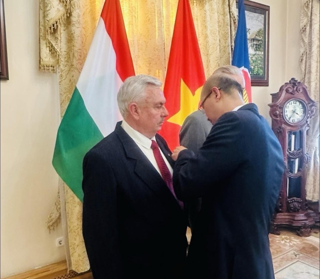 Đại sứ Việt Nam tại Hungary Bùi Lê Thái trao Huân chương Hữu nghị cho hai người bạn Hungary. (Ảnh: KT)