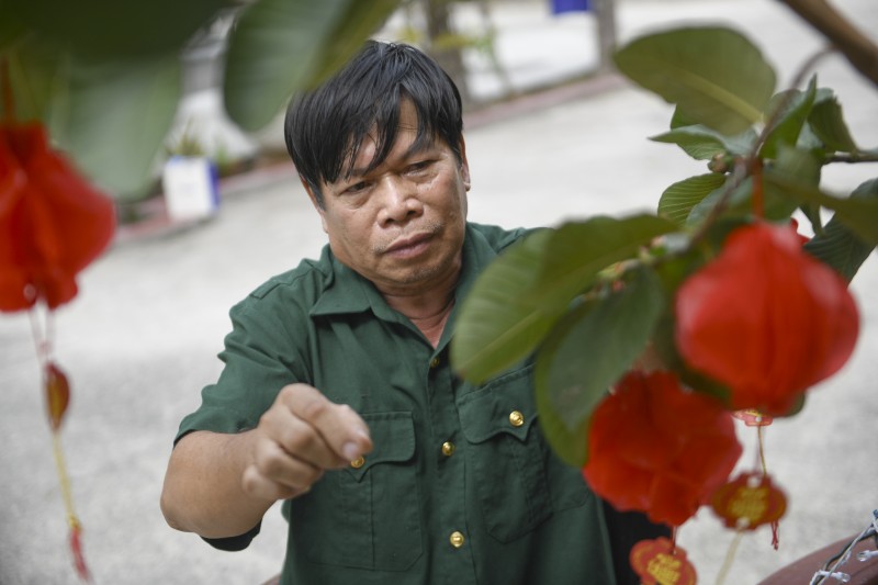 Ảnh 1A hoặc 1B: Bác Nguyễn Công Thắng – cựu chiến binh đang được chăm sóc tại Trung tâm Điều dưỡng Thương binh và Người có công Long Đất – chăm chút cho góc Tết trước phòng ở (Ảnh: Minh Anh). Ảnh 1A hoặc 1B: Bác Nguyễn Công Thắng – cựu chiến binh đang được chăm sóc tại Trung tâm Điều dưỡng Thương binh và Người có công Long Đất – chăm chút cho góc Tết trước phòng ở (Ảnh: Minh Anh).