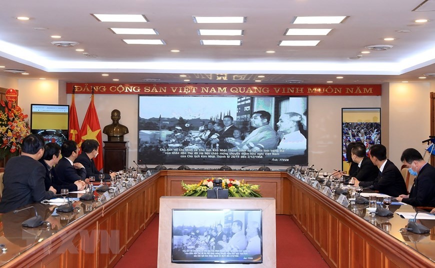 Phó Tổng giám đốc Thông tấn xã Việt Nam Nguyễn Tuấn Hùng và Tham tán, Đại biện lâm thời Đại sứ quán Cộng hòa dân chủ nhân dân Triều Tiên tại Việt Nam Ri Ho Jun cùng các đại biểu xem trình chiếu trưng bày ảnh. (Ảnh: Tuấn Anh/TTXVN)