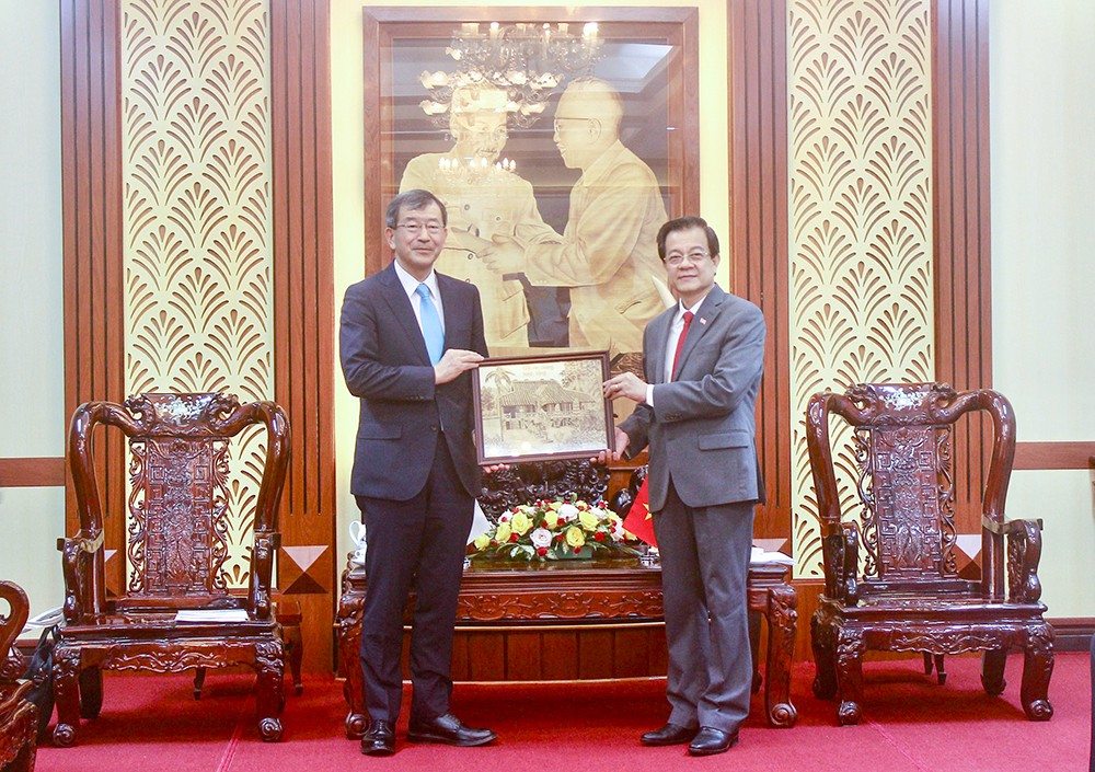 Bí thư Tỉnh ủy An Giang Lê Hồng Quang trao tặng đoàn công tác Tổng Lãnh sự quán Nhật Bản tại TP. Hồ Chí Minh bức tranh ngôi nhà thời niên thiếu của Chủ tịch Tôn Đức Thắng làm từ lá thốt nốt. (Ảnh: Báo An Giang Online)