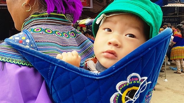 nhung em be di cho tren lung me o bac ha